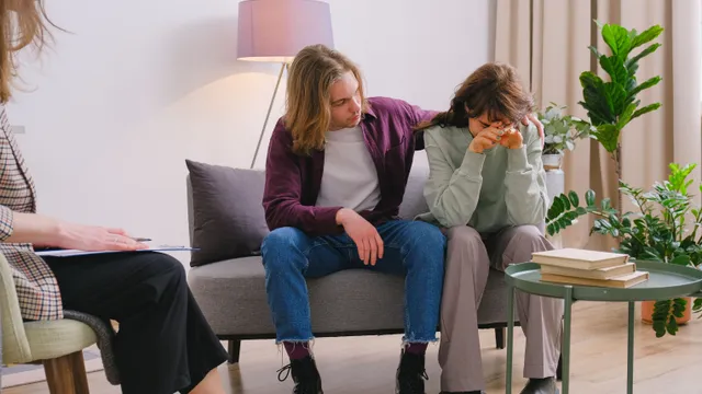 A couple supporting one another during a counselling session